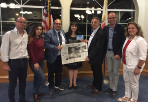 Martinez Vice Mayor Debbie McKillop, center, met with representatives from the Isola delle Femmine delegation from Sicily, as they display a newspaper special section devoted to Martinez native son Joe DiMaggio, whose parents moved to California from Sicily. From left are Marco Mogavero, vice president of the Isola delle Femmine-Pittsburg Committee; Viviana Gradino, a member of the Isola city council; Isola Mayor Stefano Bologna; McKillop; Antonio Scala, president of the Isola-Pittsburg sister city committee; Pietro S. Rappa; and Dr. Anna Maria Lucido Lo Dico. (Courtesy of Debbie McKillop)